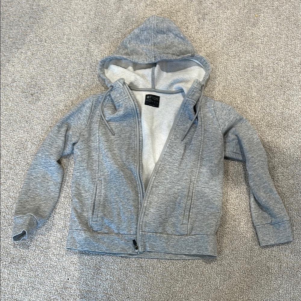 Gray zip-up hoodie with soft cotton-blend fabric and lined hood